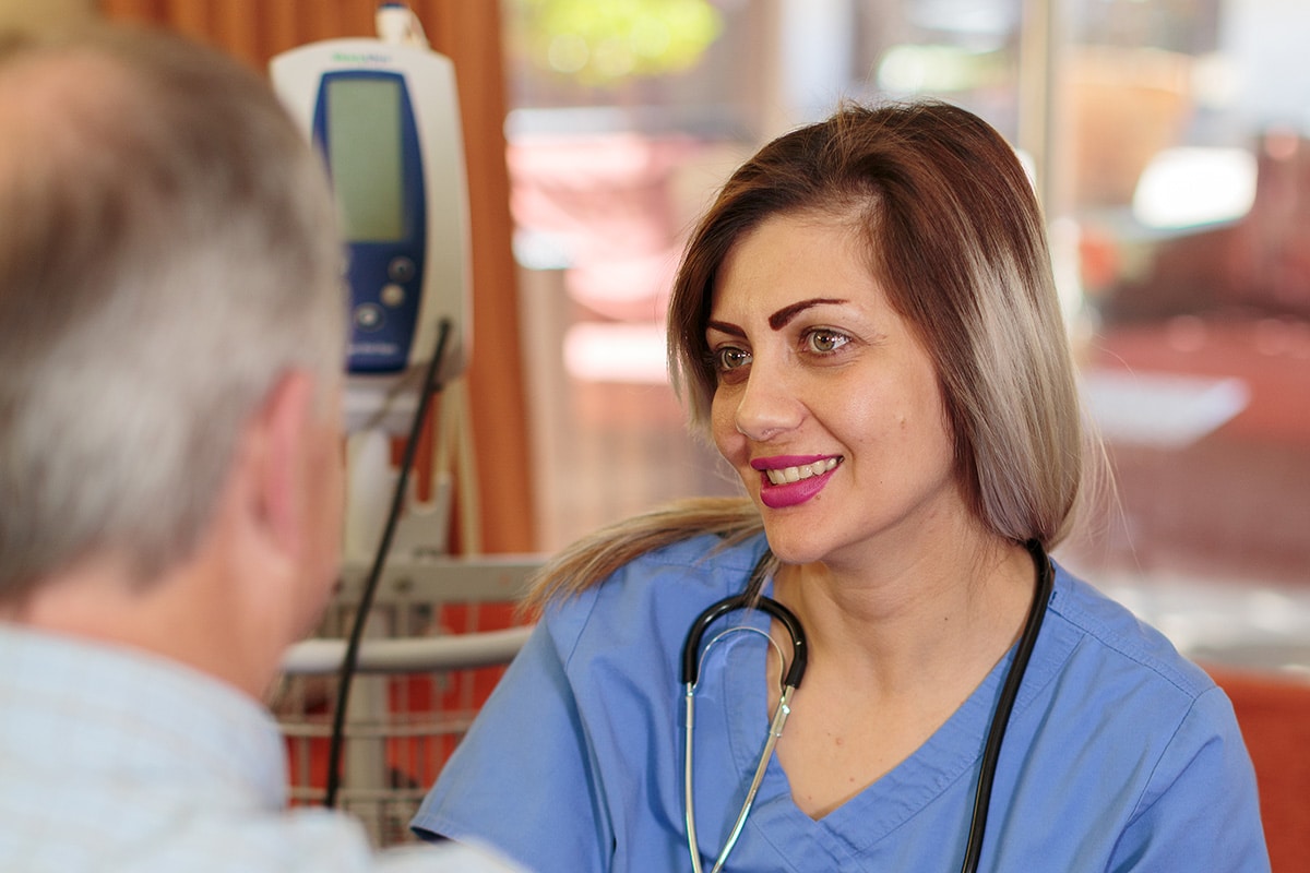 A caregiver with a resident at Villa Las Palmas