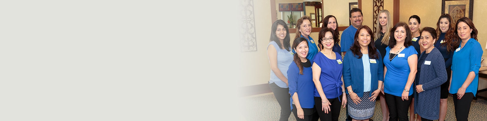 Several staff and caregivers in the hallway of Villa Las Palmas